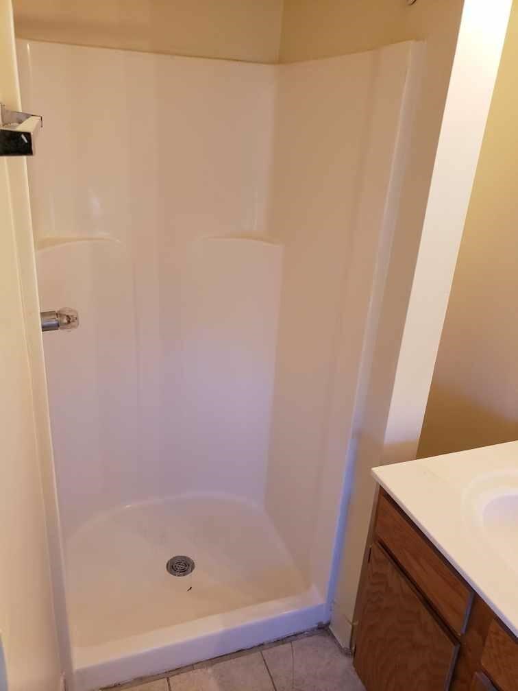 a bathroom with a shower and a sink